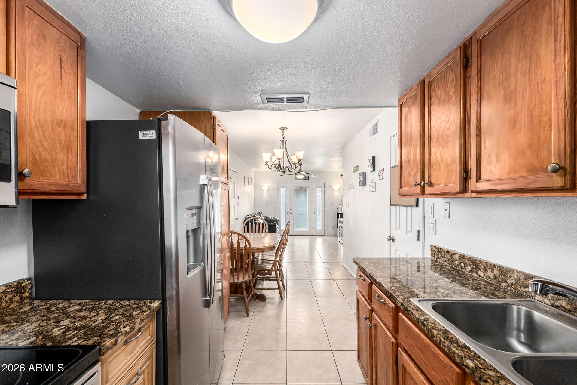 600 South Dobson Road, Unit 122 Mesa, AZ 85202 - Photo 19 of 28 a kitchen with stainless steel appliances granite countertop a sink stove and refrigerator