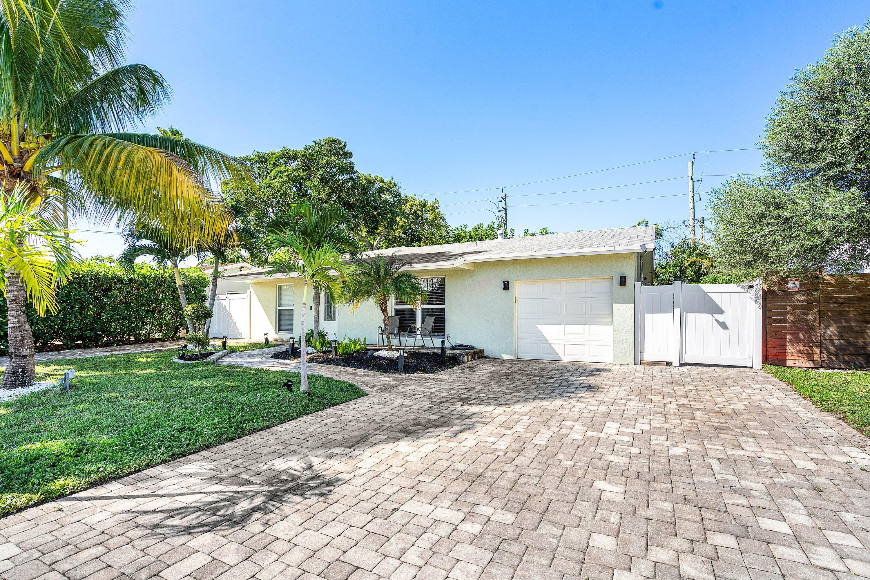 22207 Southwest 65th Terrace Boca Raton, FL 33428 - Photo 1 of 27 a view of a house with a yard and potted plants