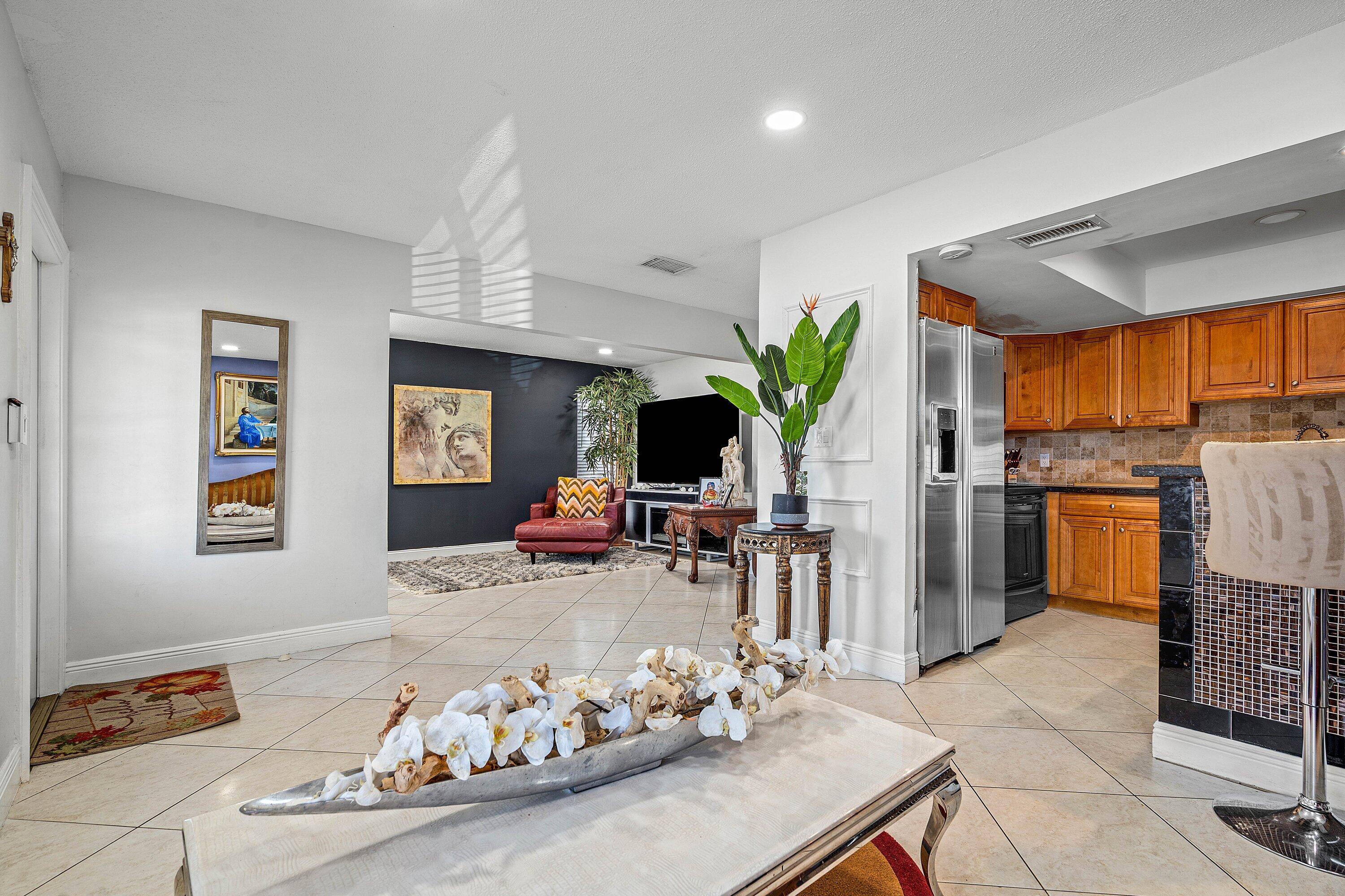 22207 Southwest 65th Terrace Boca Raton, FL 33428 - Photo 11 of 27 a living room with furniture fireplace and a window