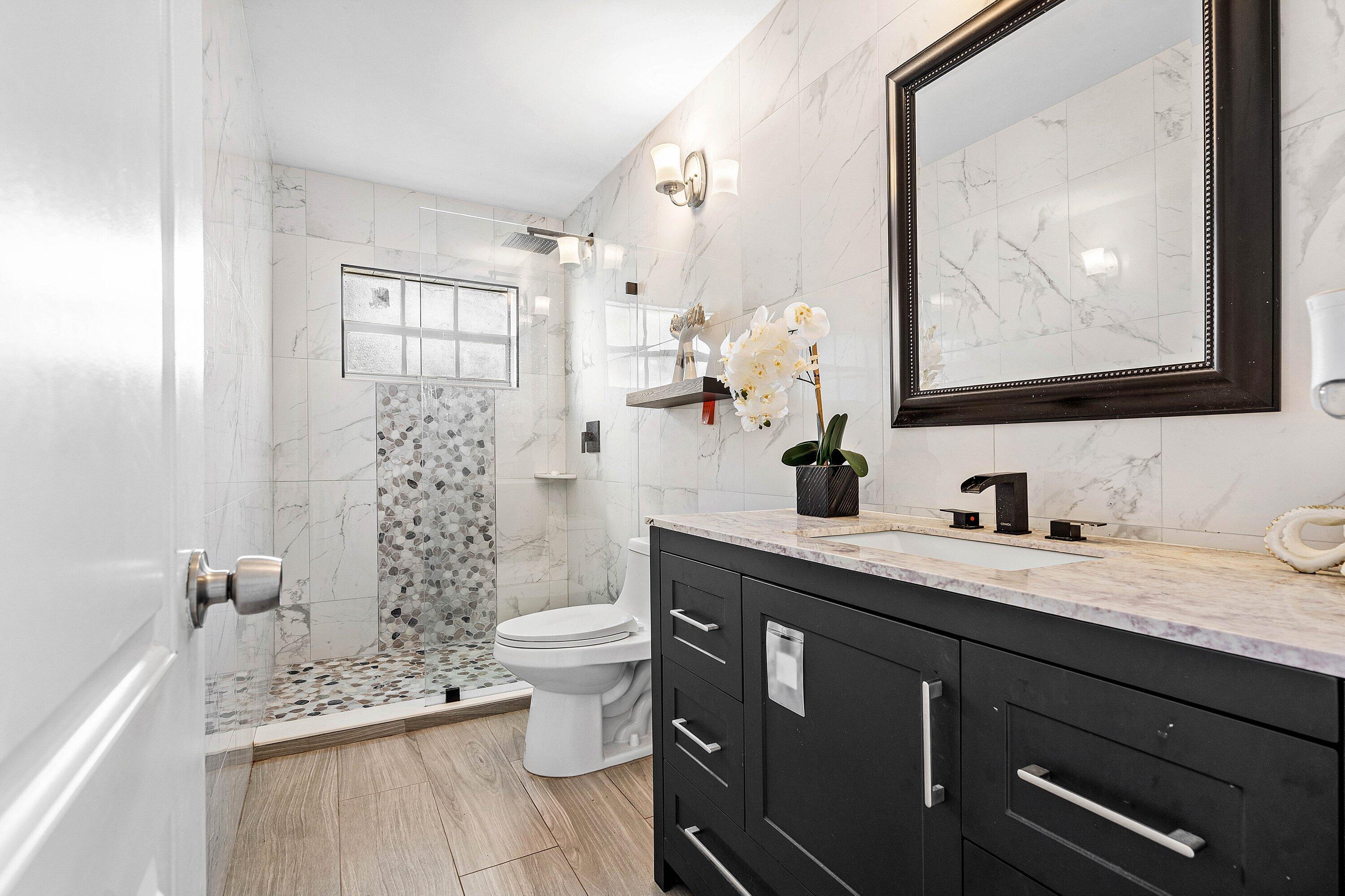 22207 Southwest 65th Terrace Boca Raton, FL 33428 - Photo 14 of 27 a bathroom with a granite countertop toilet sink and mirror