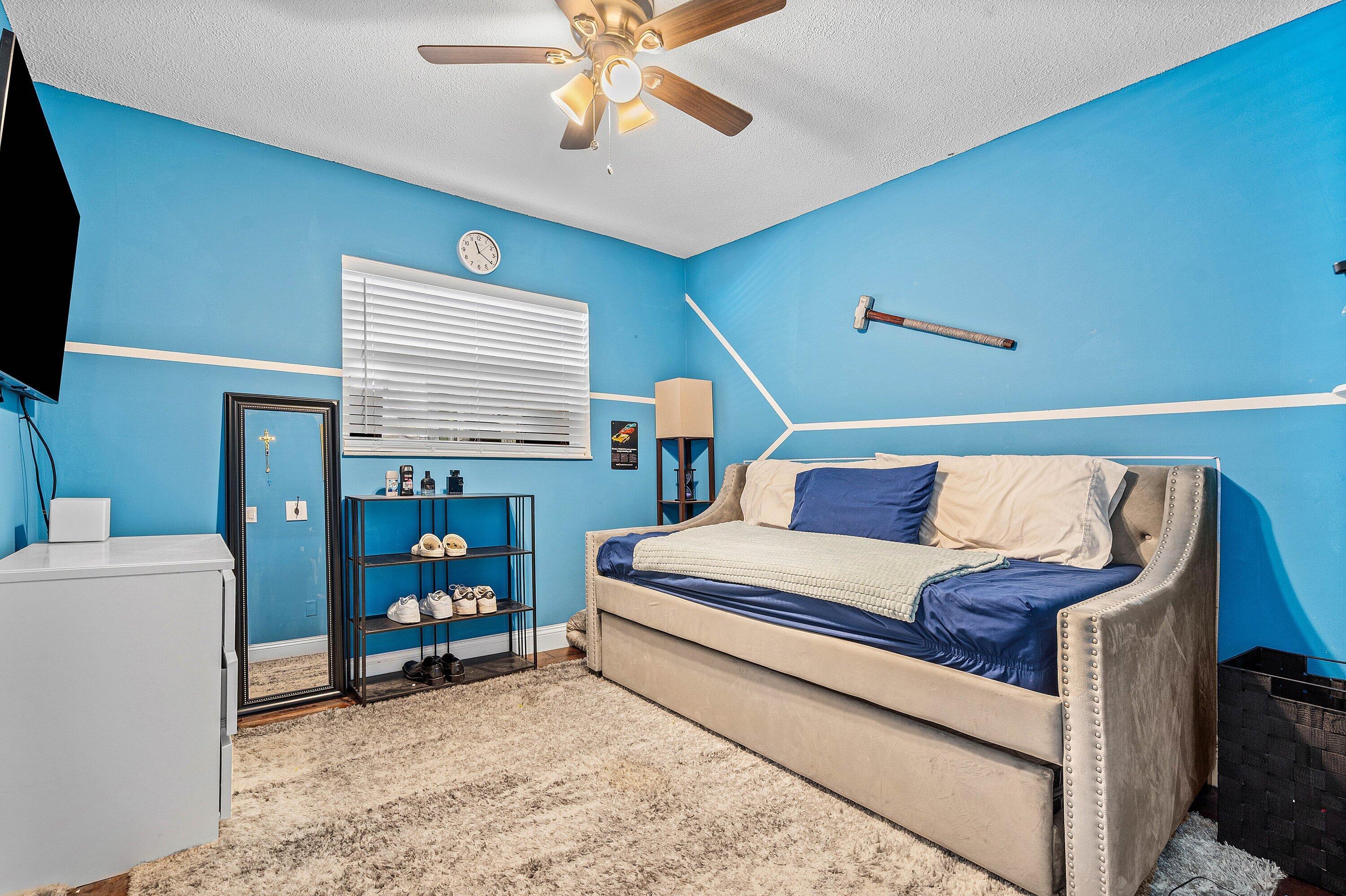 22207 Southwest 65th Terrace Boca Raton, FL 33428 - Photo 15 of 27 a bedroom with furniture and a bed