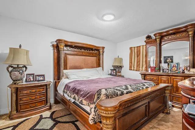 a bedroom with a bed and a dresser in it