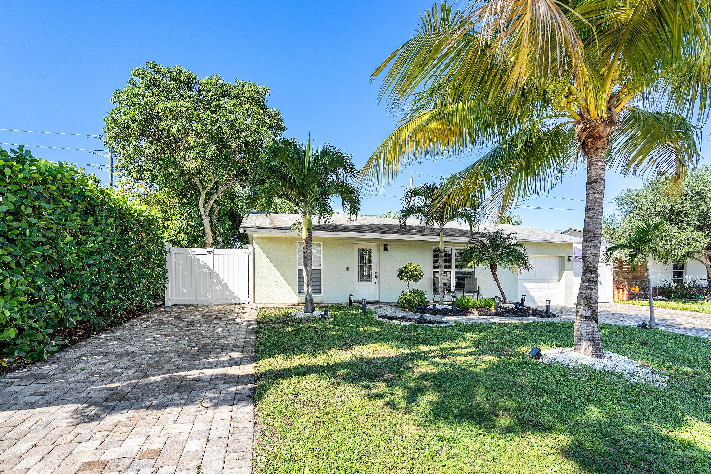 22207 Southwest 65th Terrace Boca Raton, FL 33428 - Photo 2 of 27 a front view of a house with a yard
