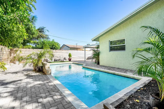 a view of a swimming pool with an outdoor seating