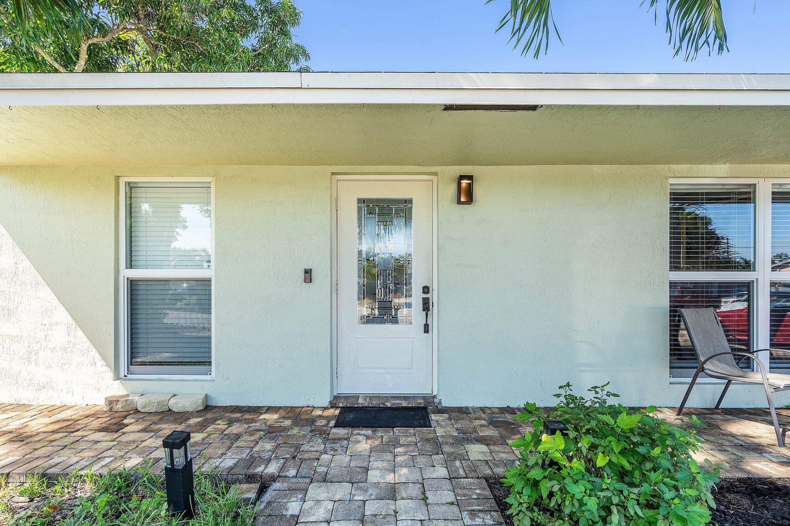22207 Southwest 65th Terrace Boca Raton, FL 33428 - Photo 4 of 27 a front view of a house with a yard