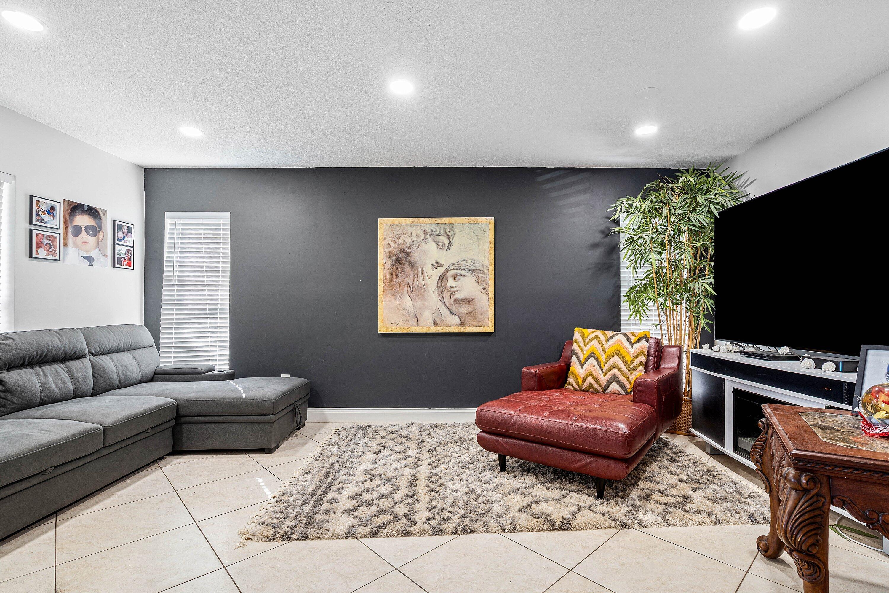 22207 Southwest 65th Terrace Boca Raton, FL 33428 - Photo 8 of 27 a living room with furniture and a flat screen tv