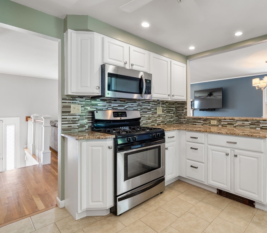 26 Crest Road Framingham, MA 01702 - Photo 15 of 39 a kitchen with stainless steel appliances granite countertop a stove a sink and a microwave
