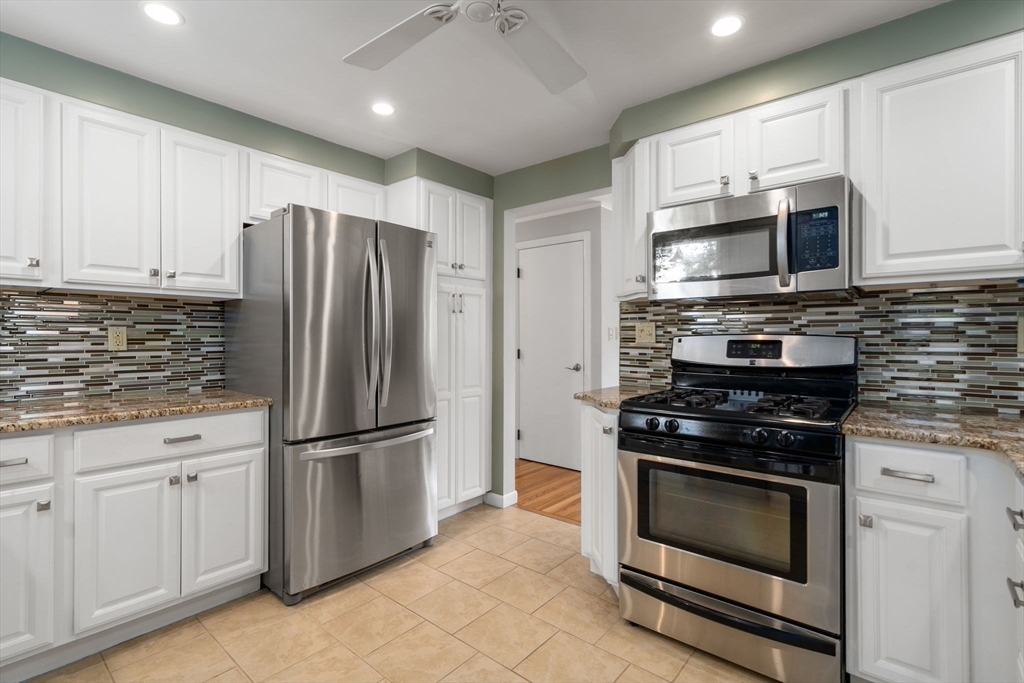 26 Crest Road Framingham, MA 01702 - Photo 17 of 39 a kitchen with stainless steel appliances granite countertop a stove a refrigerator and a microwave