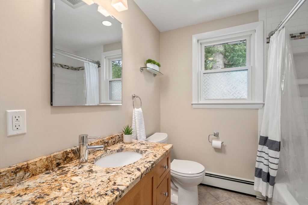26 Crest Road Framingham, MA 01702 - Photo 24 of 39 a bathroom with a granite countertop sink toilet and mirror