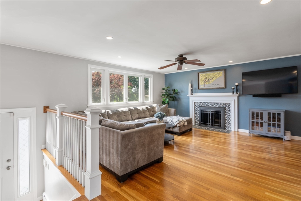 26 Crest Road Framingham, MA 01702 - Photo 10 of 39 a living room with furniture a fireplace and a flat screen tv