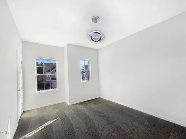 a view of a room that has a window and wooden floor