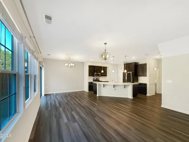 a view of a living room with furniture and flat screen tv