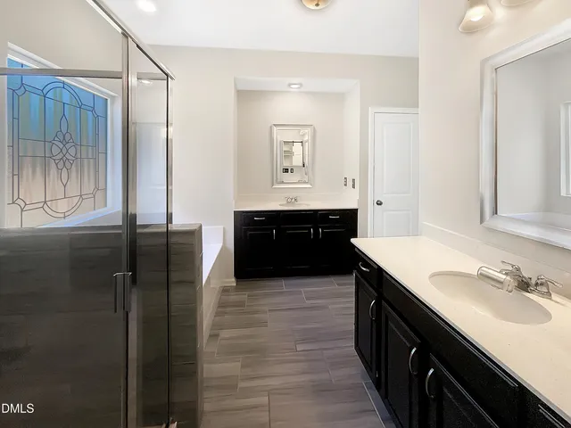 a spacious bathroom with a sink and a mirror
