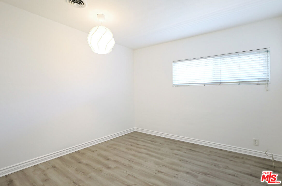 262 MacDonald Street Pasadena, CA 91103 - Photo 11 of 22 an empty room with wooden floor and windows