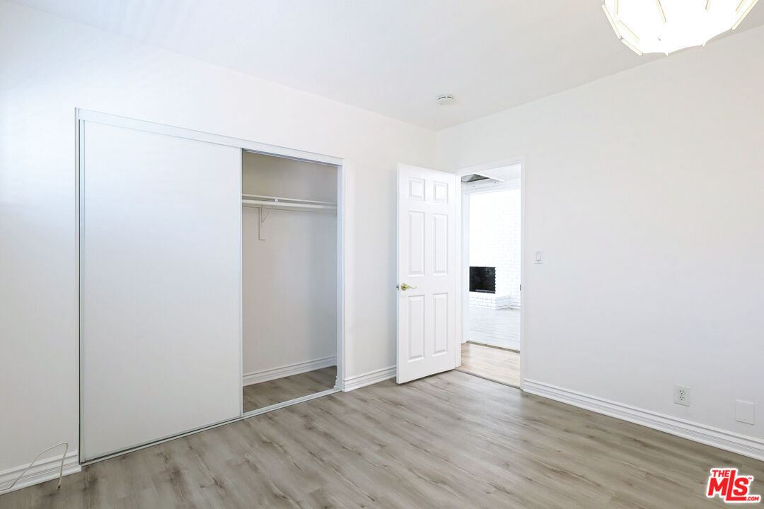 262 MacDonald Street Pasadena, CA 91103 - Photo 12 of 22 a view of an empty room with wooden floor and a window