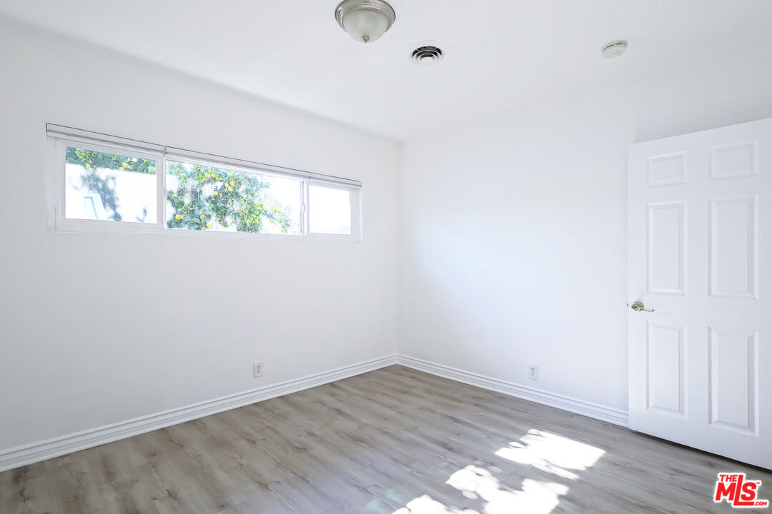 262 MacDonald Street Pasadena, CA 91103 - Photo 13 of 22 an empty room with wooden floor and windows
