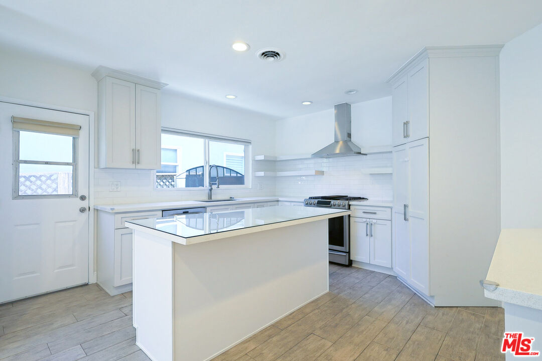 262 MacDonald Street Pasadena, CA 91103 - Photo 3 of 22 a kitchen with stainless steel appliances granite countertop a sink stove and refrigerator