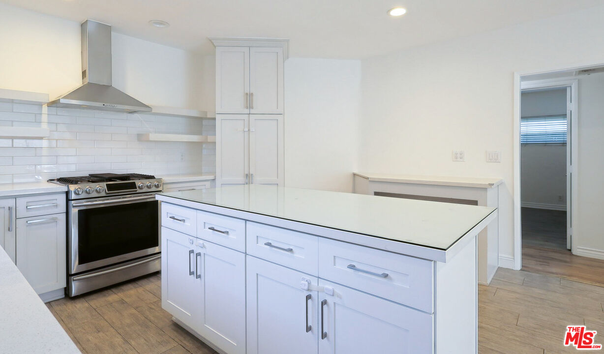 262 MacDonald Street Pasadena, CA 91103 - Photo 5 of 22 a kitchen with white cabinets and appliances