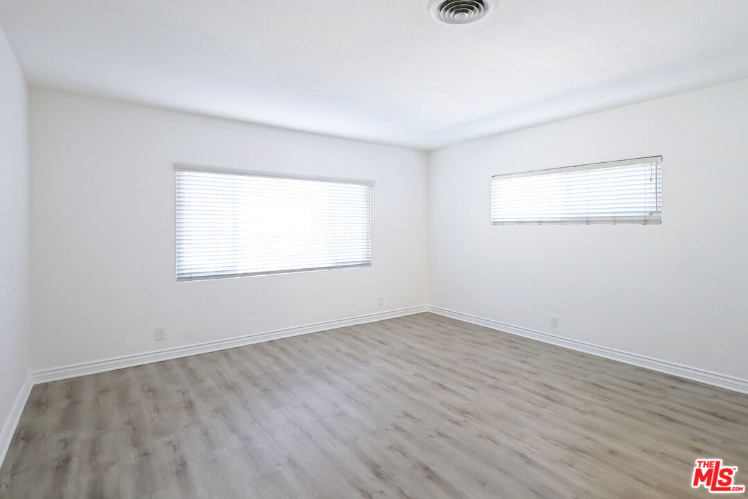 262 MacDonald Street Pasadena, CA 91103 - Photo 7 of 22 an empty room with wooden floor and windows