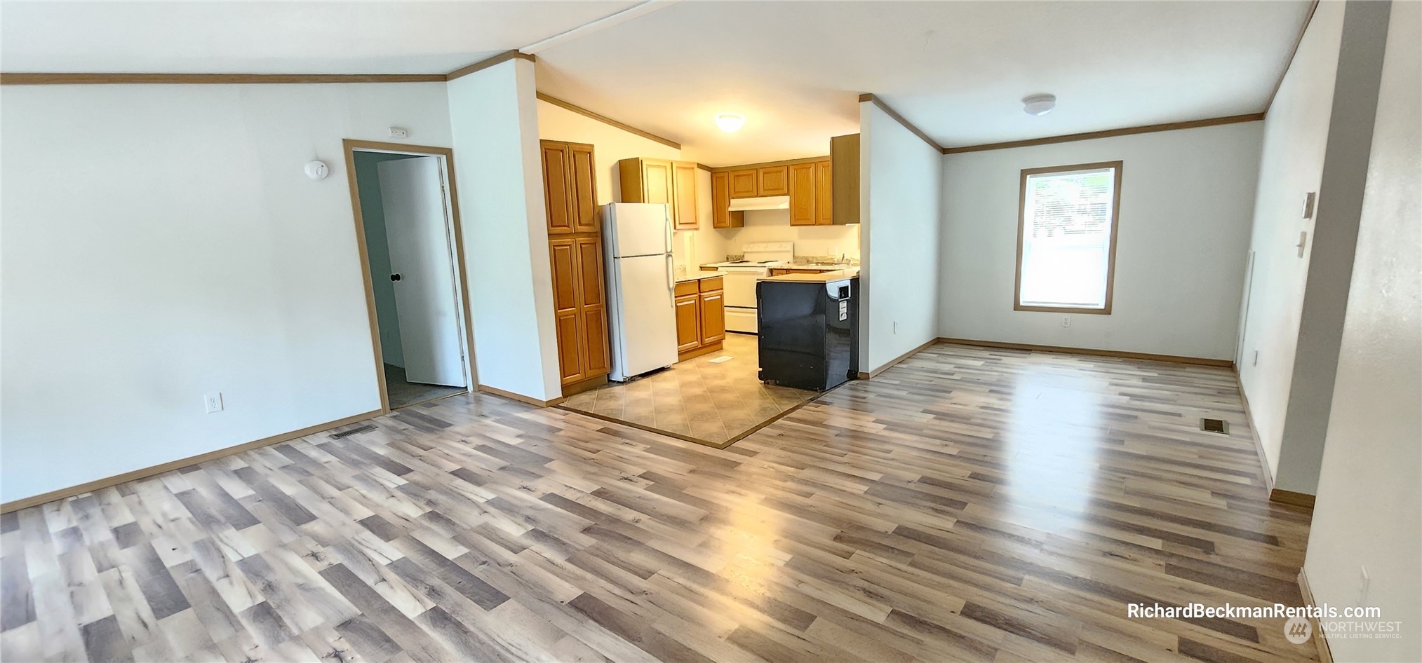 40 Southeast My Road Shelton, WA 98584 - Photo 13 of 25 a view of a kitchen with fridge and wooden floor