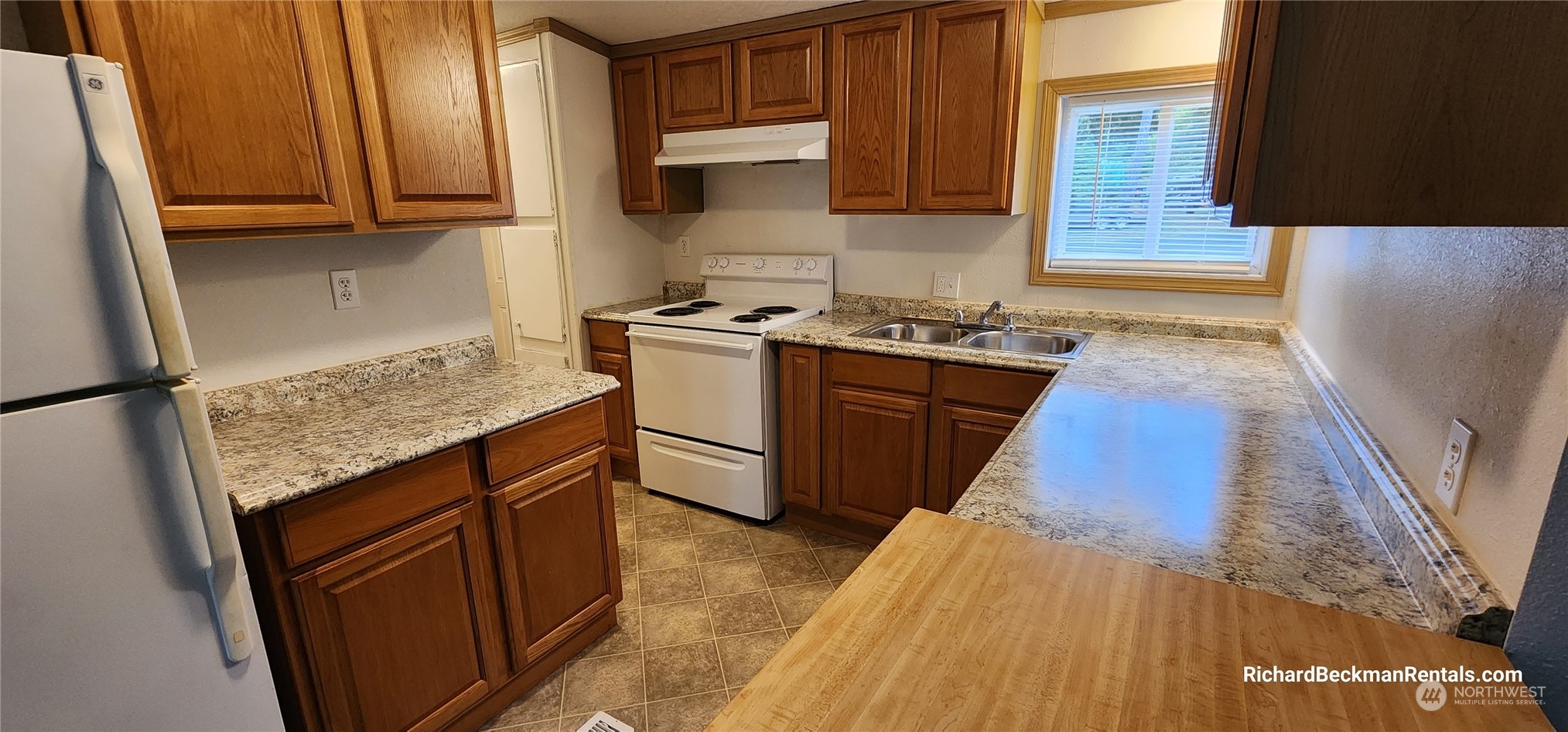 40 Southeast My Road Shelton, WA 98584 - Photo 5 of 25 a kitchen with granite countertop wooden cabinets and a stove top oven