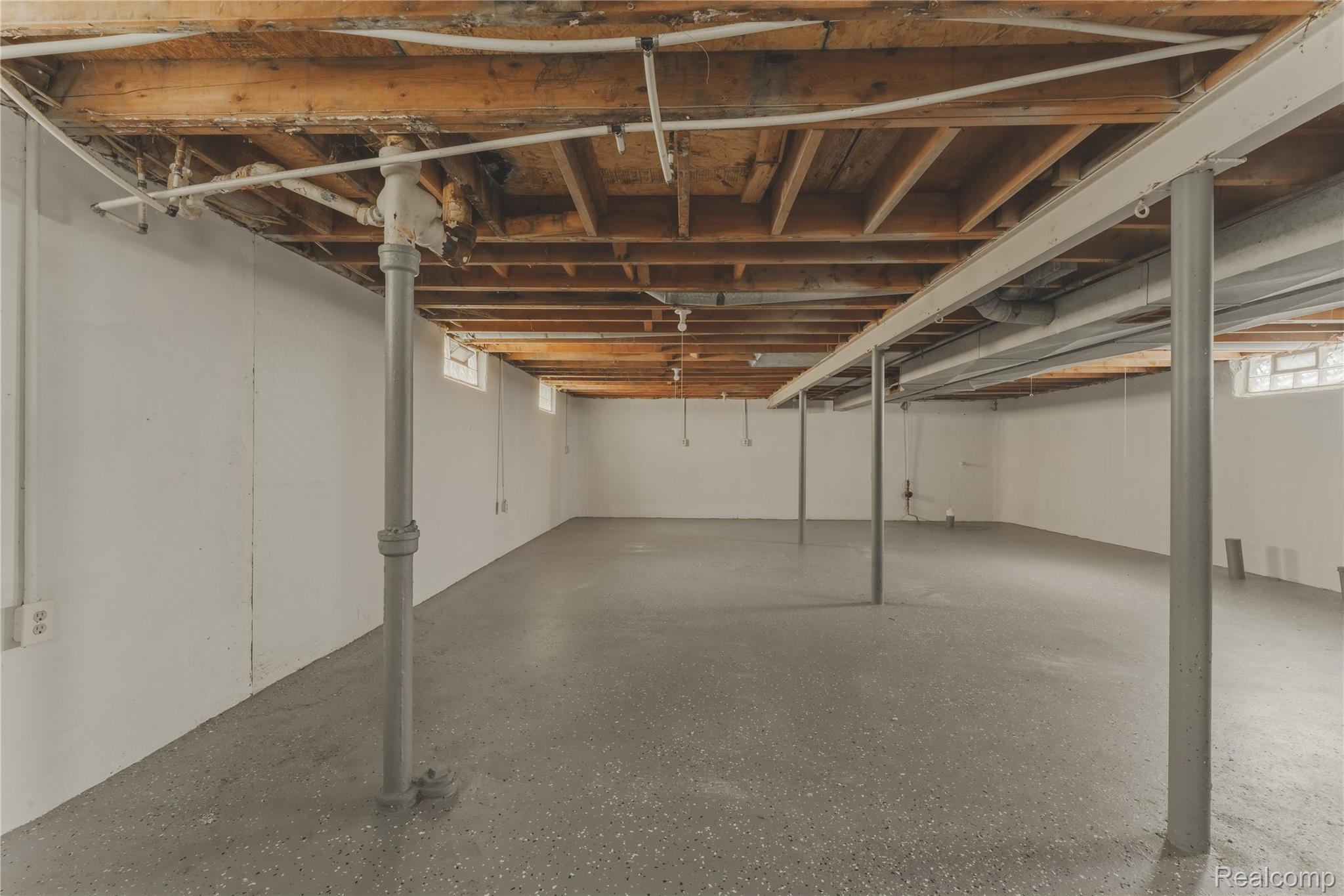 93 West Princeton Avenue Pontiac, MI 48340 - Photo 24 of 31 Expansive lower level featuring a concrete floor, painted white walls, and exposed wood ceiling joists