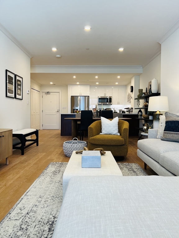 201 Sherman Road, Unit 403 Brookline, MA 02467 - Photo 12 of 25 a living room with furniture and kitchen view