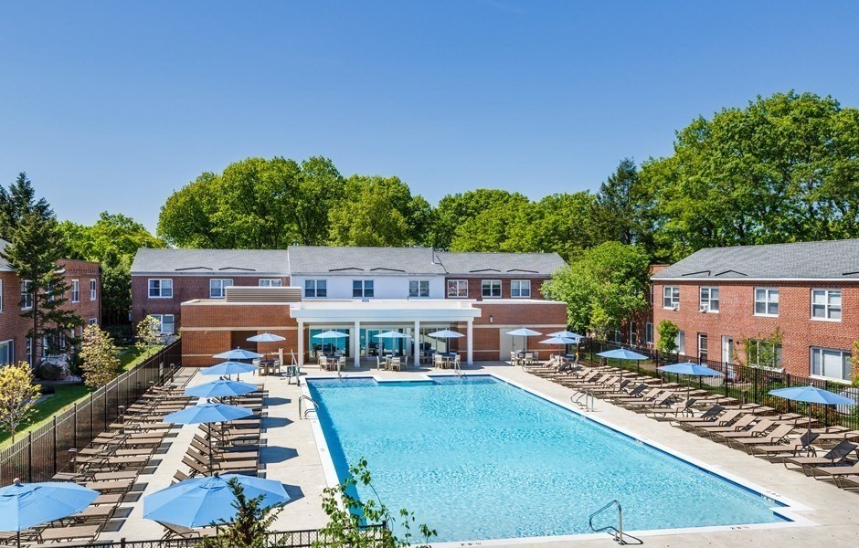 201 Sherman Road, Unit 403 Brookline, MA 02467 - Photo 4 of 25 an aerial view of a house with swimming pool and red chairs