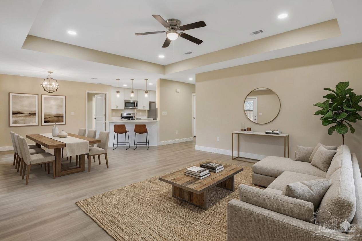 295 West Kingsfield Road Cantonment, FL 32533 - Photo 11 of 47 a living room with furniture a rug kitchen view and a chandelier