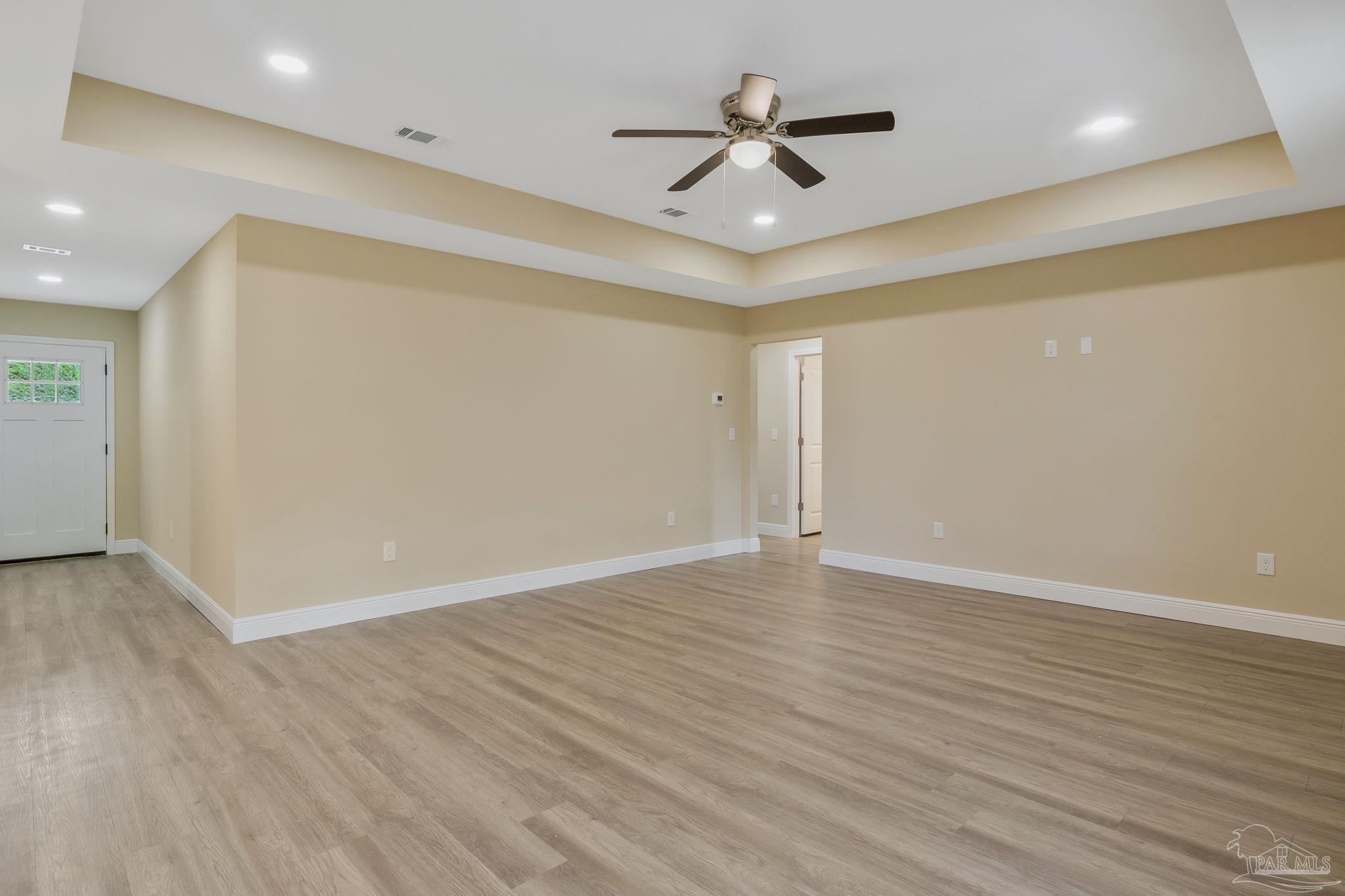295 West Kingsfield Road Cantonment, FL 32533 - Photo 14 of 47 an empty room with wooden floor and ceiling fan