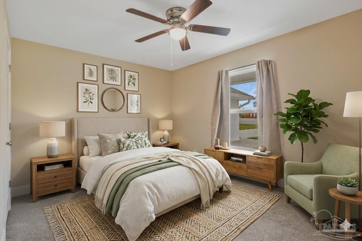 295 West Kingsfield Road Cantonment, FL 32533 - Photo 24 of 47 a bedroom with a bed a couch and a potted plant