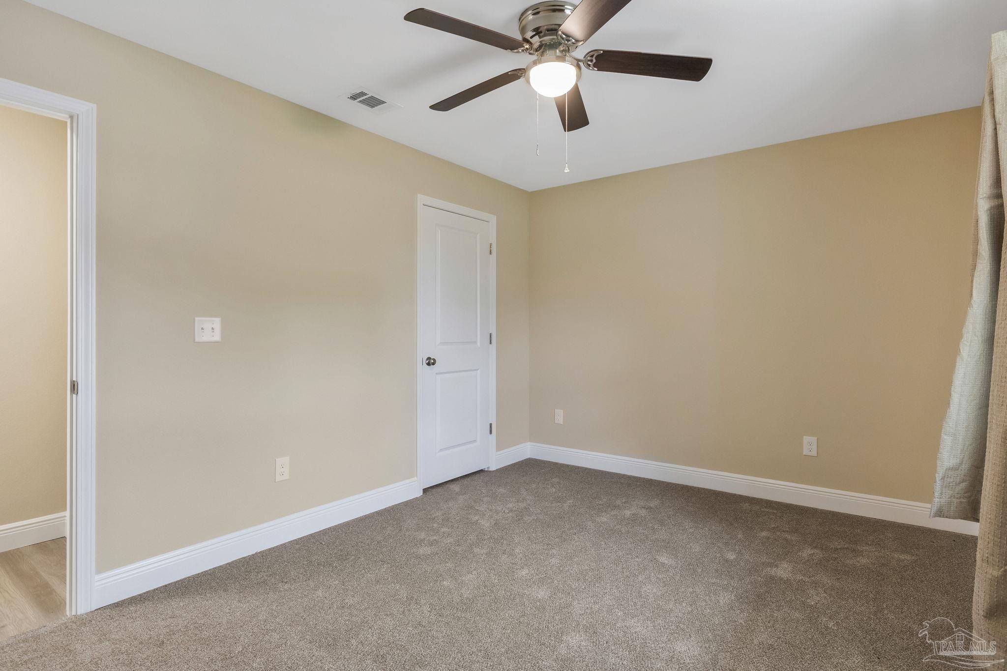 295 West Kingsfield Road Cantonment, FL 32533 - Photo 29 of 47 an empty room with a window and a fan