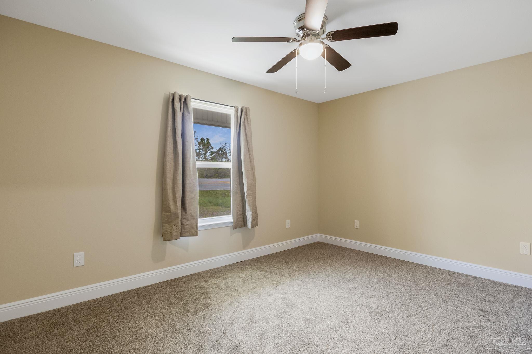 295 West Kingsfield Road Cantonment, FL 32533 - Photo 31 of 47 an empty room with a window and a fan