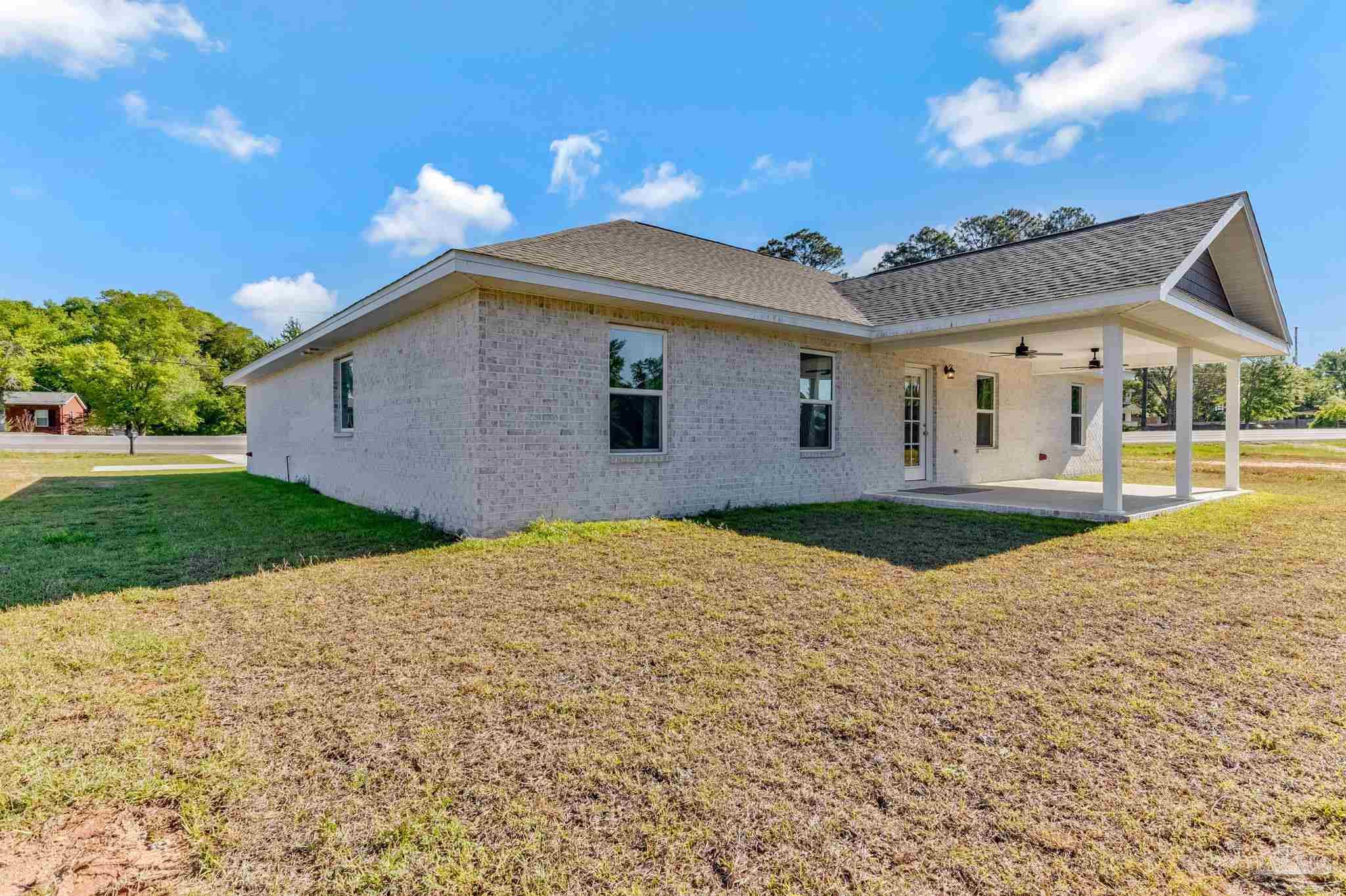 295 West Kingsfield Road Cantonment, FL 32533 - Photo 42 of 47 a front view of a house with a yard and garage