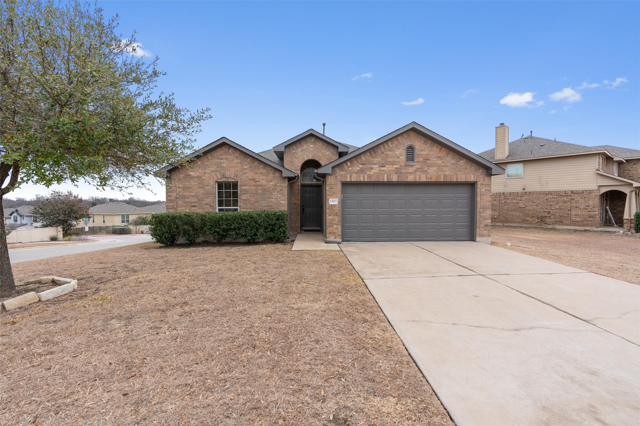 a front view of a house with a yard and garage