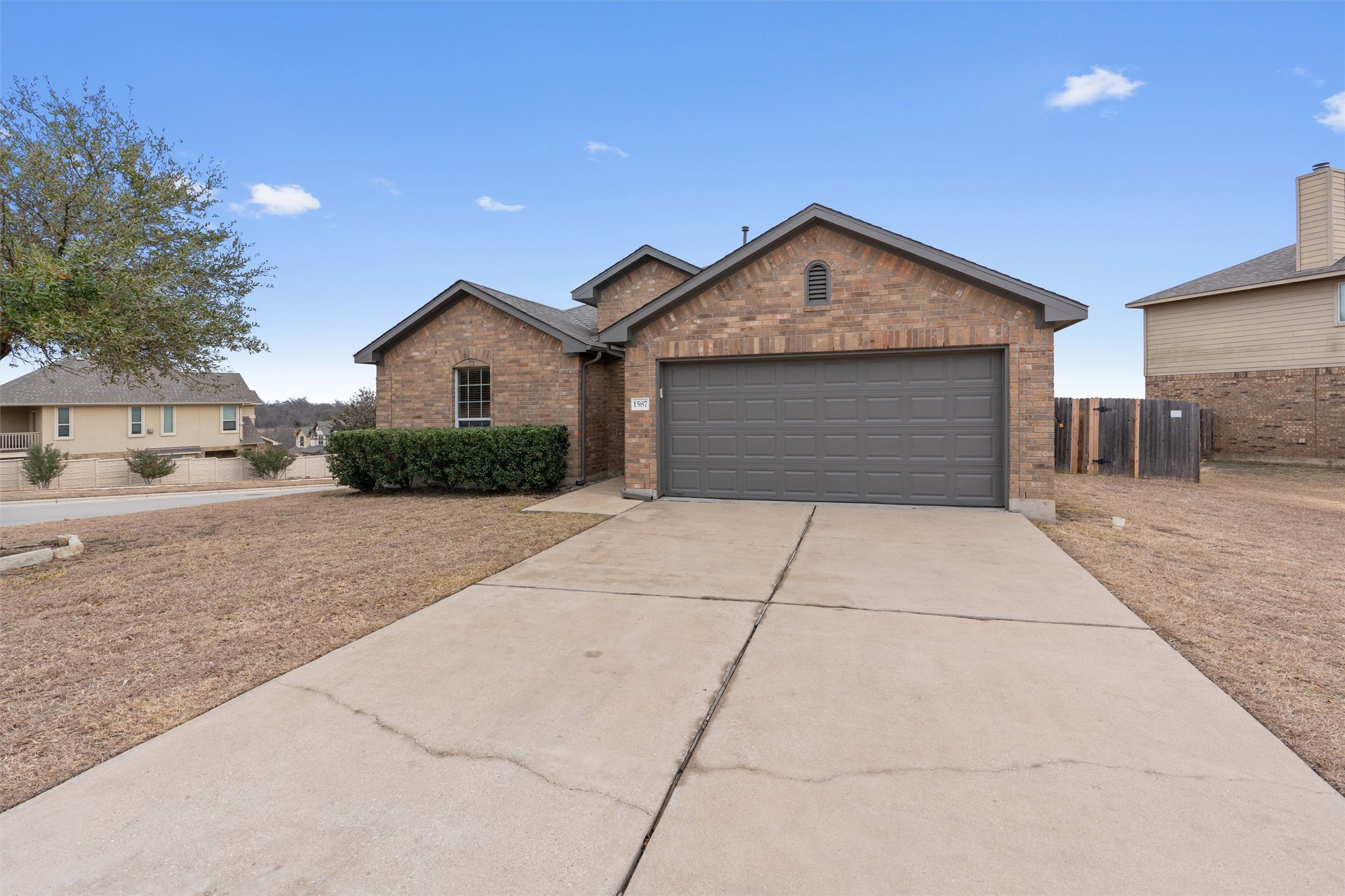 1587 Haynie Bend Round Rock, TX 78665 - Photo 2 of 25 a front view of a house with a yard and garage