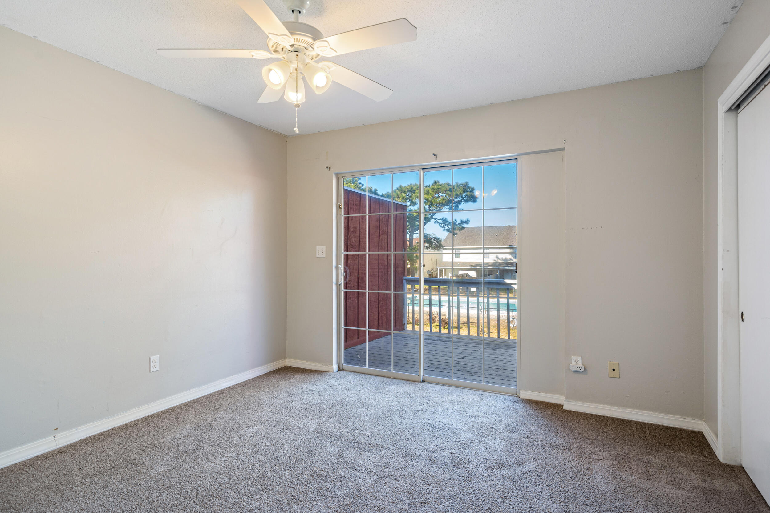 145 4th Avenue, Unit C2 Shalimar, FL 32579 - Photo 15 of 35 an empty room with a ceiling fan and a window