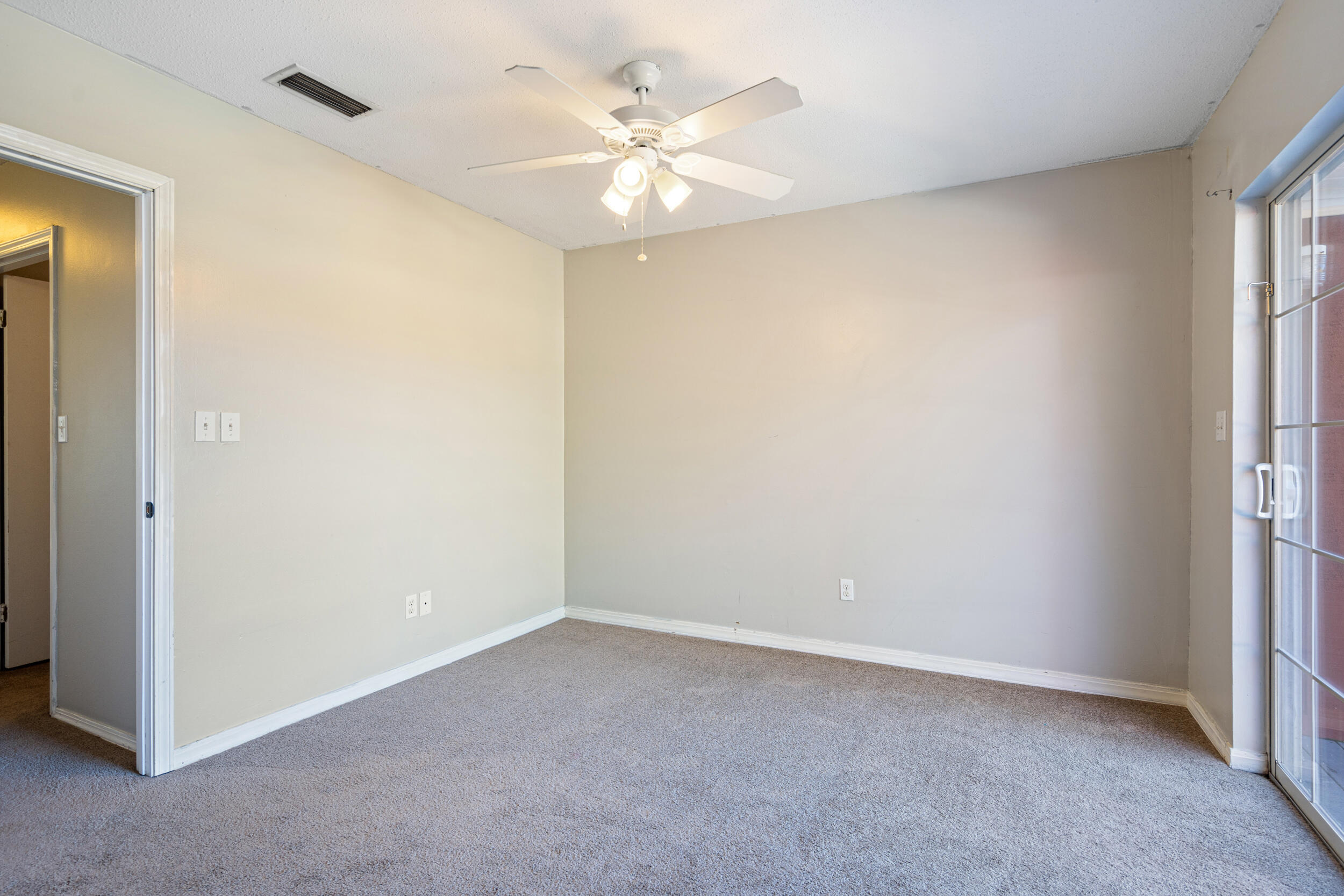 145 4th Avenue, Unit C2 Shalimar, FL 32579 - Photo 16 of 35 an empty room with a ceiling fan and a window