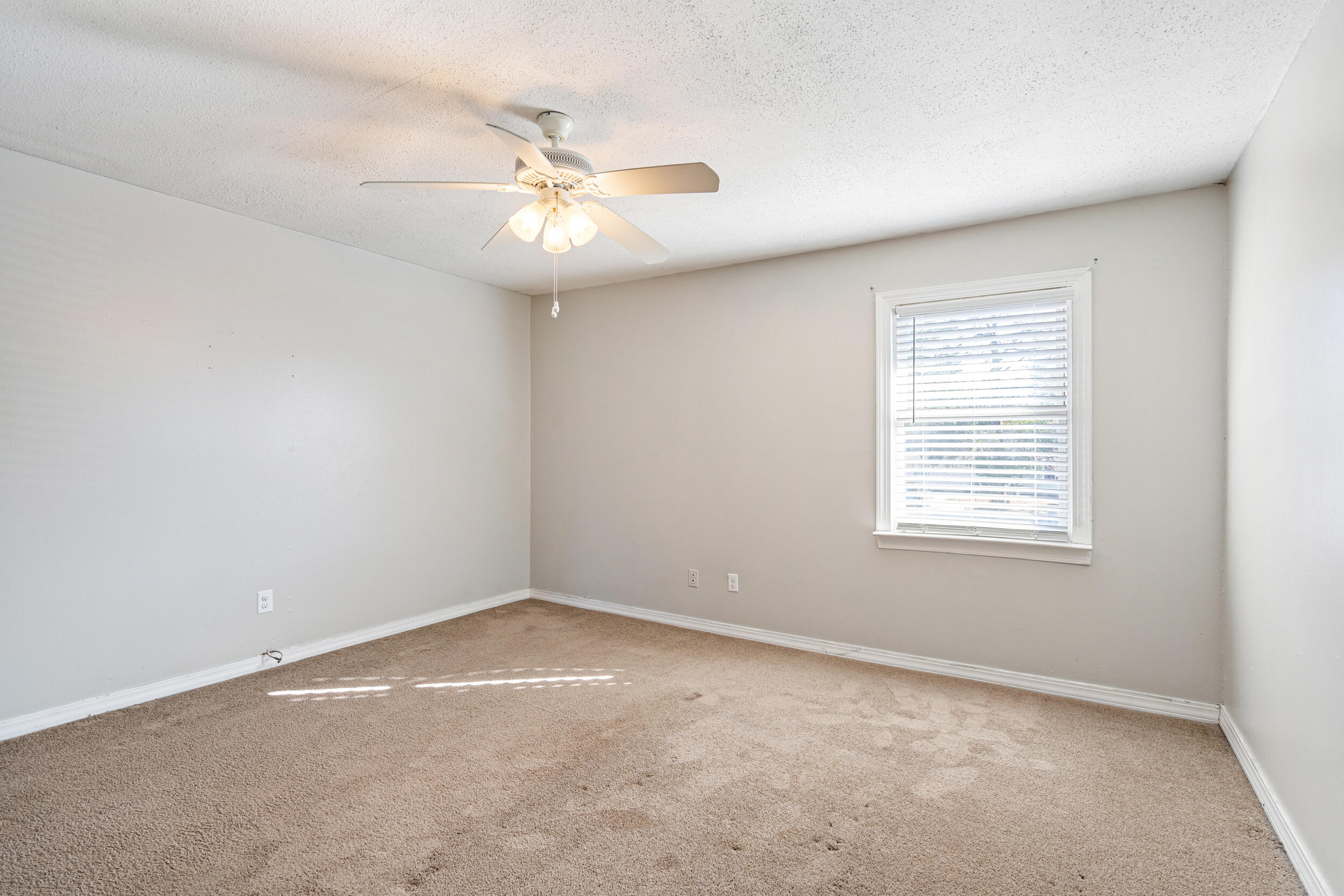 145 4th Avenue, Unit C2 Shalimar, FL 32579 - Photo 23 of 35 an empty room with a window and a fan