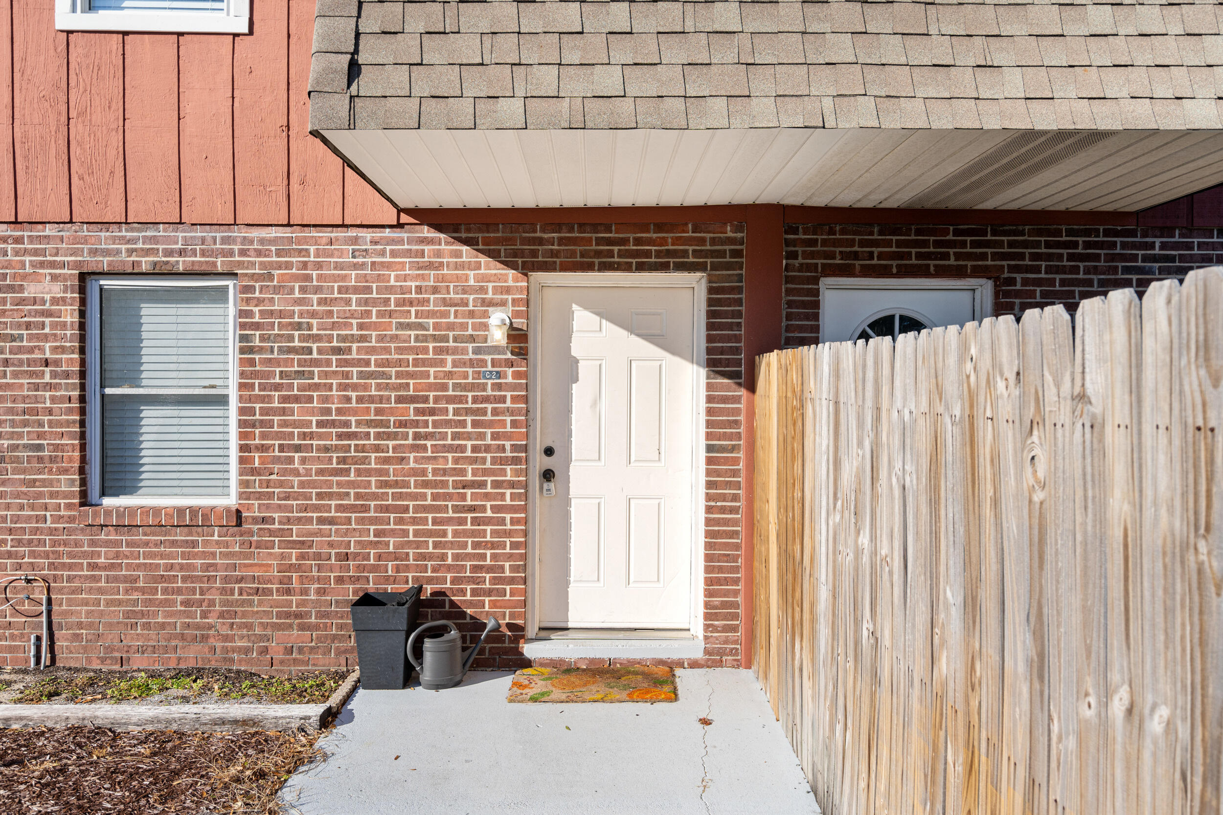 145 4th Avenue, Unit C2 Shalimar, FL 32579 - Photo 3 of 35 a front view of a house with a garden