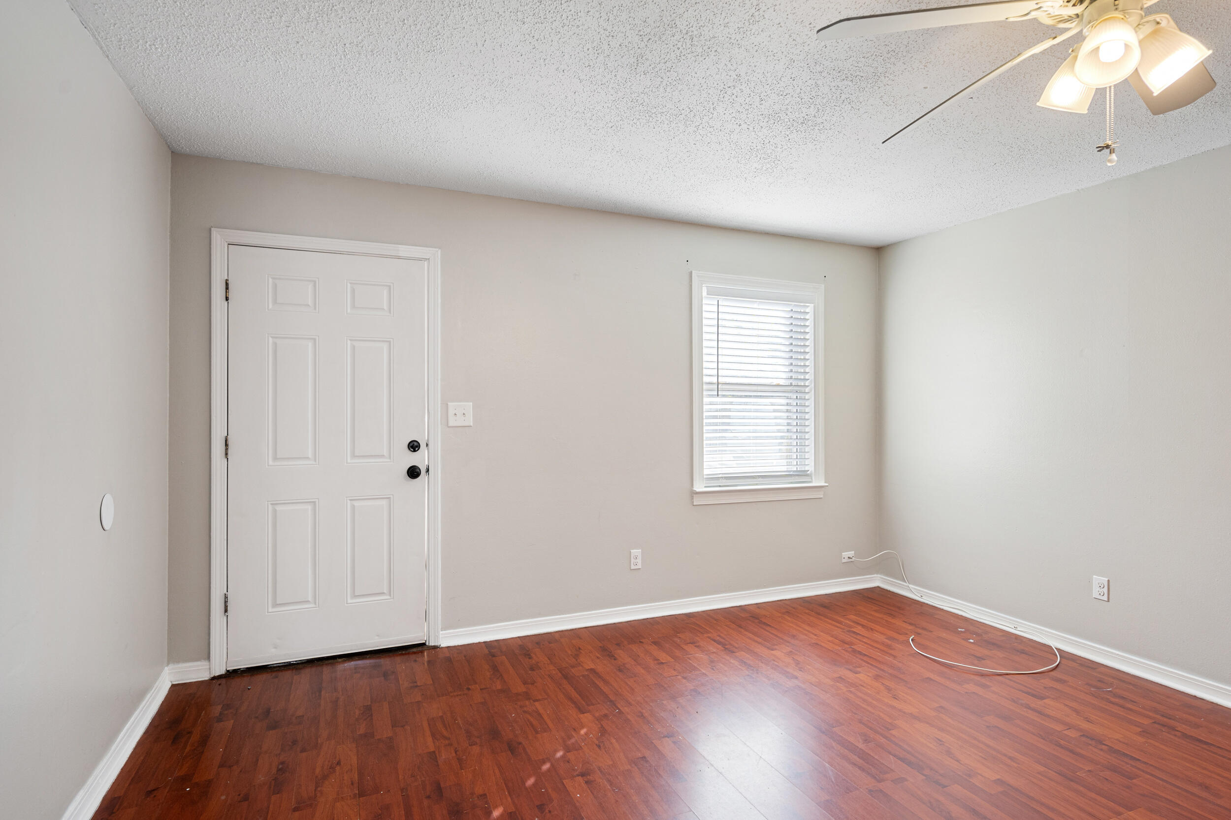 145 4th Avenue, Unit C2 Shalimar, FL 32579 - Photo 4 of 35 a view of an empty room with wooden floor and a window