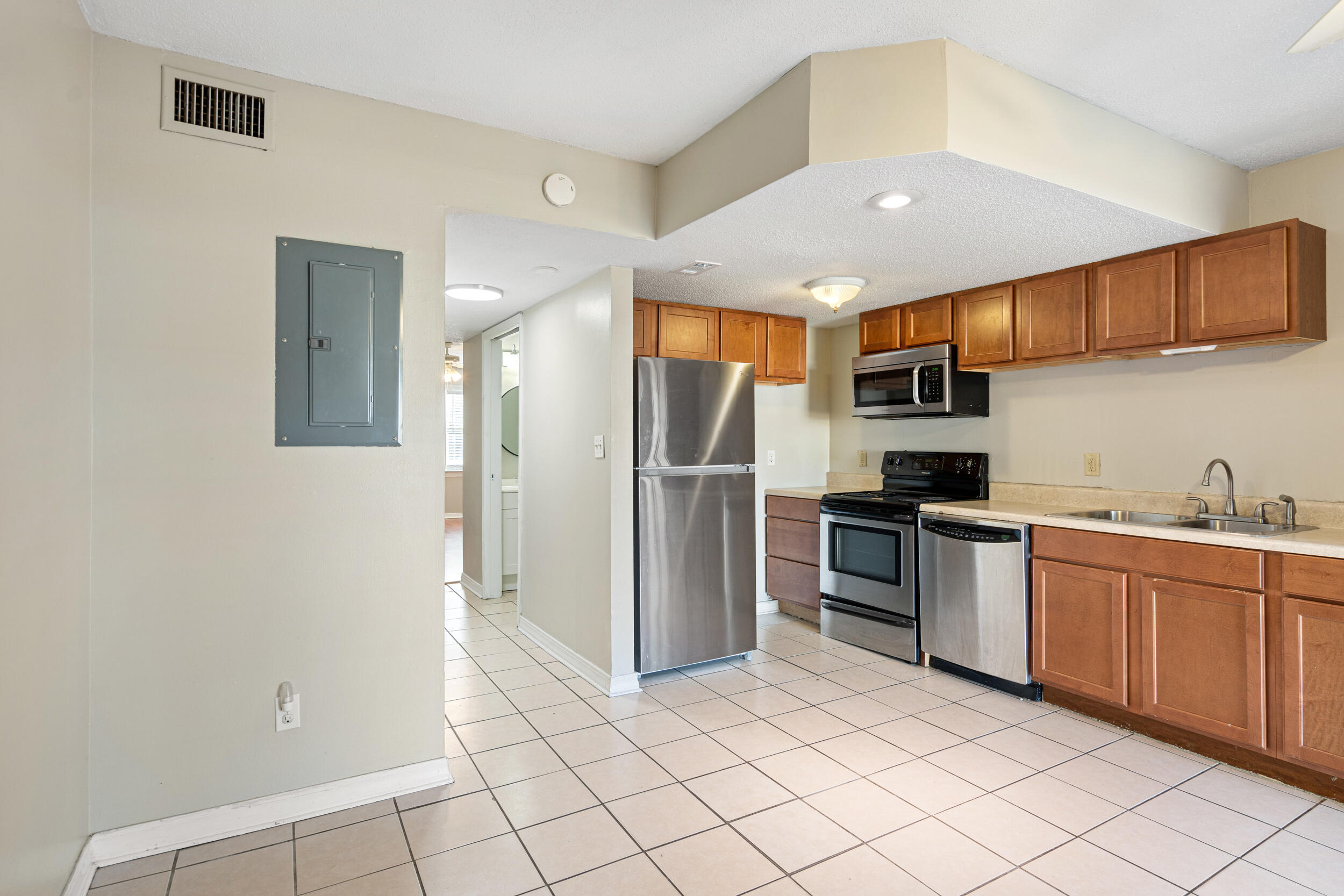 145 4th Avenue, Unit C2 Shalimar, FL 32579 - Photo 10 of 35 a kitchen with stainless steel appliances granite countertop a refrigerator and a sink