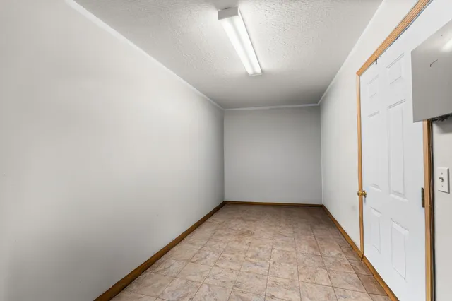 an empty room with a empty space and windows