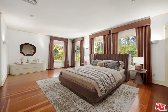 a bedroom with a large bed and a large window