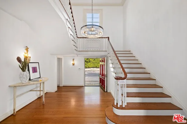 a view of entryway and hall with wooden floor