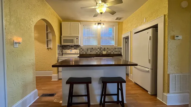 a kitchen with a table and chairs