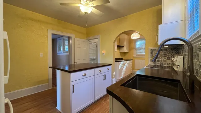 a kitchen with stainless steel appliances granite countertop a stove and a sink