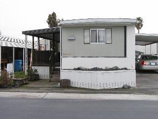 386 Ricardo Avenue Santa Rosa, CA 95407 - Photo 1 of 4 a front view of a house with a garden and parking