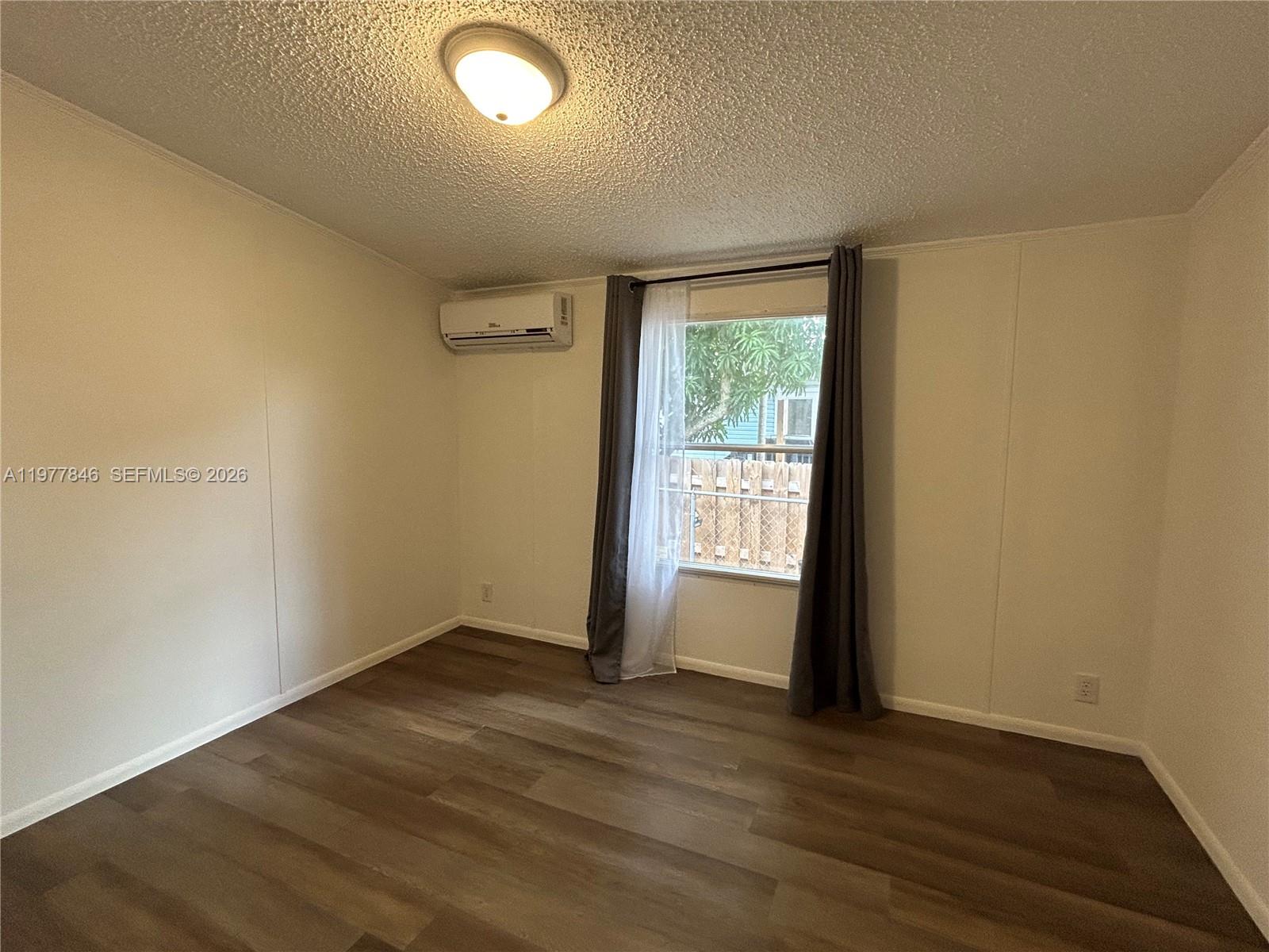 10467 South 228th Lane, Unit A Boca Raton, FL 33428 - Photo 12 of 27 an empty room with wooden floor and windows