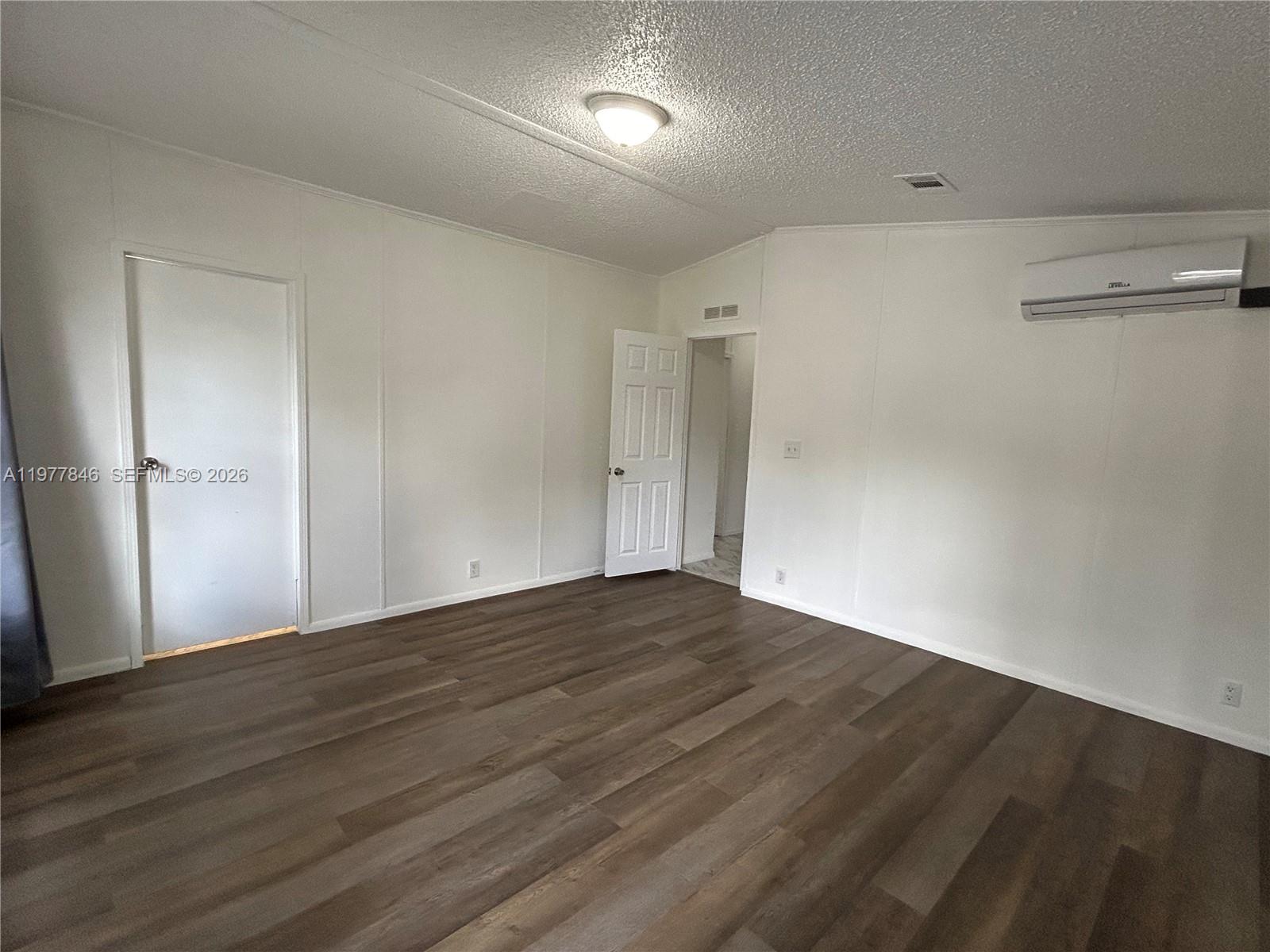 10467 South 228th Lane, Unit A Boca Raton, FL 33428 - Photo 17 of 27 a view of an empty room with wooden floor
